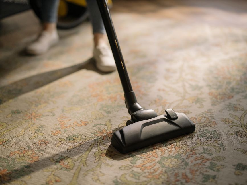 Vacuuming carpet floor carefully
